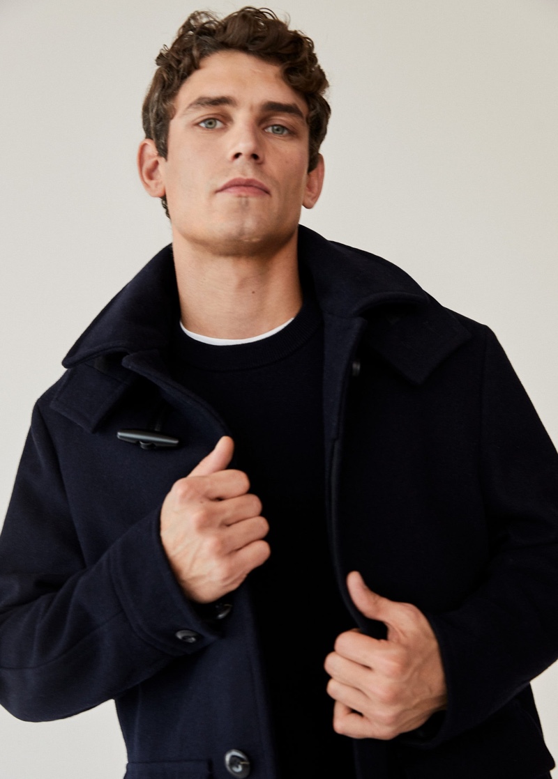 Connecting with Mango, Arthur Gosse wears a recycled cashmere and merino wool sweater with a long recycled wool coat.