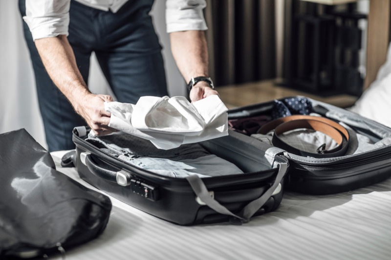 Businessman Packing Suitcase Bed