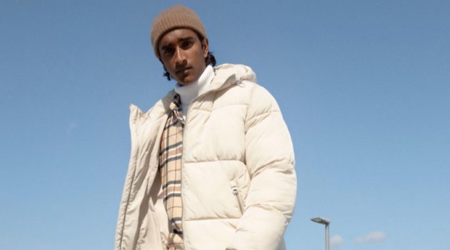 Jeenu Models Winter Neutrals for H&M Donning winter neutrals for H&M, Jeenu Mahadevan sports the brand's slim-fit suit pants with a puffer jacket and flannel shirt.