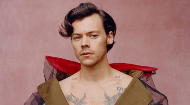 Harry Styles Lands First Solo Male Vogue Cover, Talks Fashion Front and center, Harry Styles wears a trench coat by Maison Margiela for Vogue.