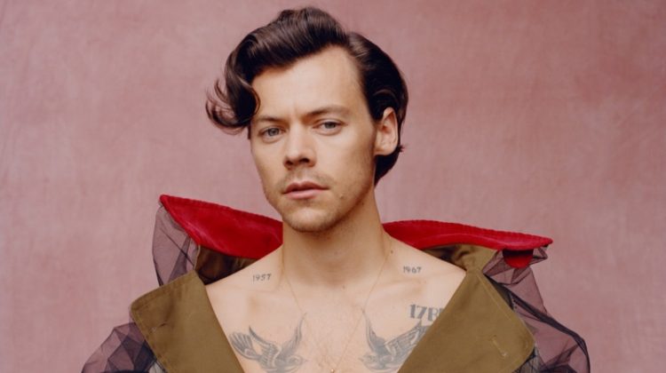 Front and center, Harry Styles wears a trench coat by Maison Margiela for Vogue.