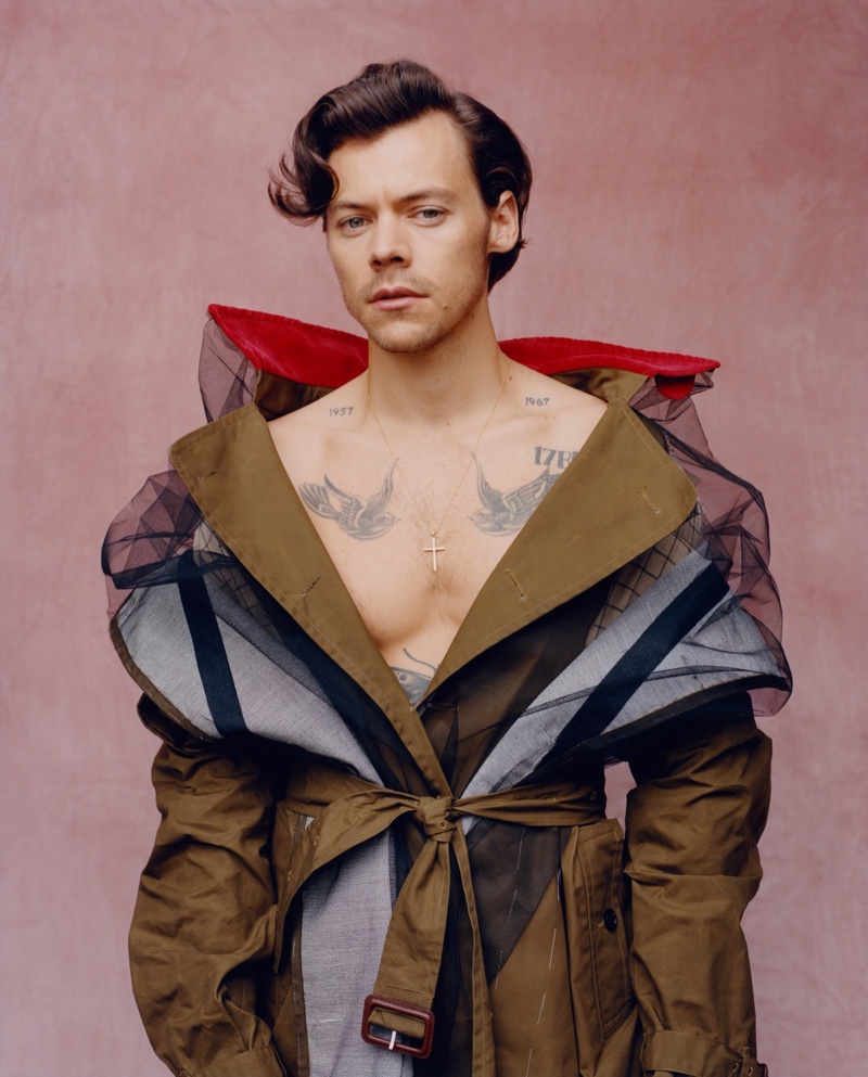 Front and center, Harry Styles wears a trench coat by Maison Margiela for Vogue.