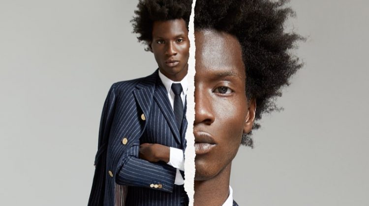Making a sartorial statement, Adonis Bosso dons a pinstripe wool suit and coat by Thom Browne for Holt Renfrew's fall-winter 2020 campaign.