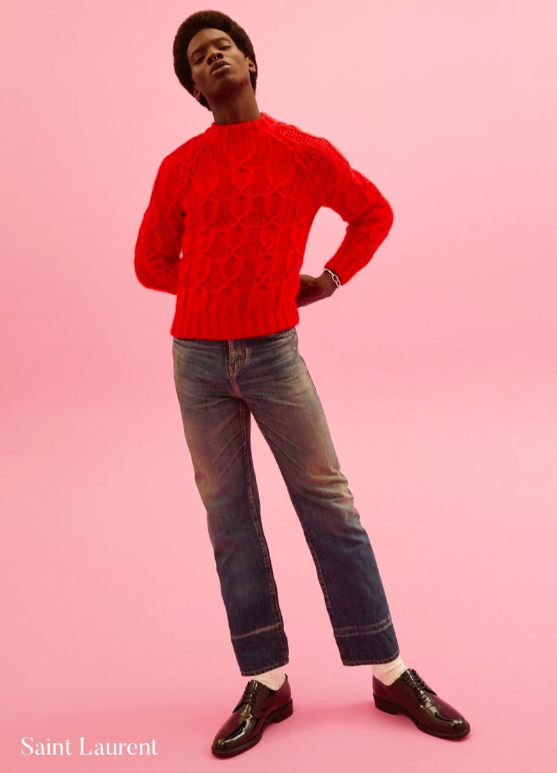 Front and center, Adonis Bosso rocks a red cable-knit sweater by Saint Laurent for Holt Renfrew.