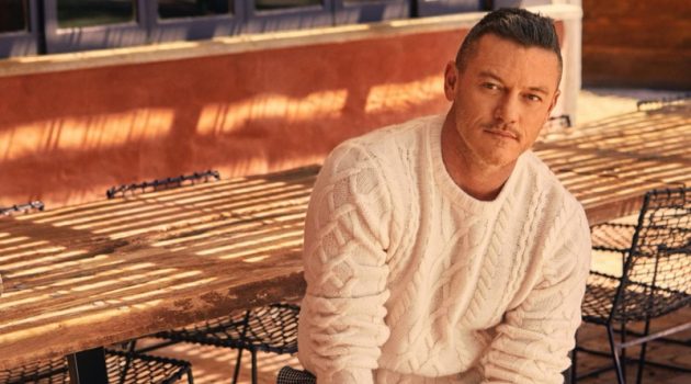 Luke Evans Inspires in Todd Snyder Styles Actor Luke Evans sports a Todd Snyder cable fisherman's sweater in off white with cream and black houndstooth wool pleated pants.