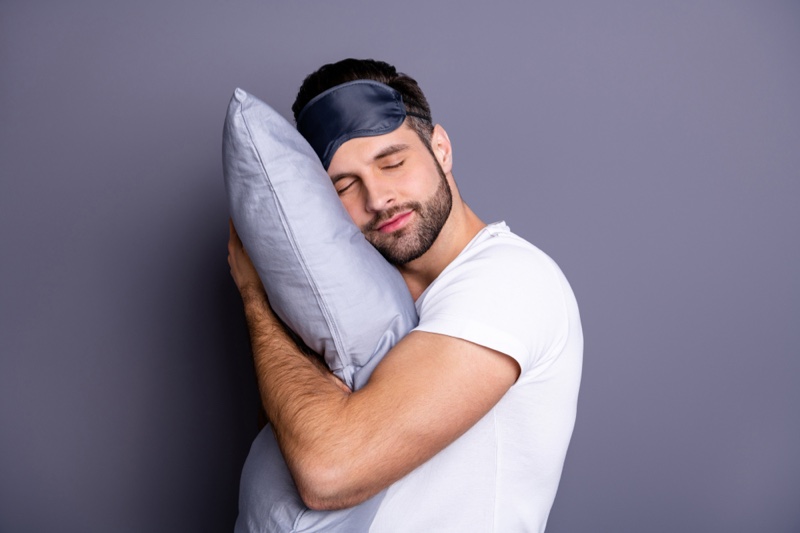 Male Model Holding Pillow Sleeping Mask White Tee