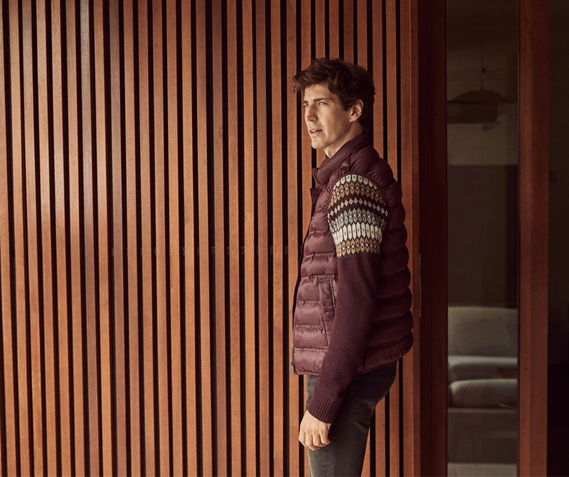 Reuniting with Pedro del Hierro for fall, Oriol Elcacho wears a burgundy-colored sweater with a matching quilted vest and grey cashmere feel jeans.