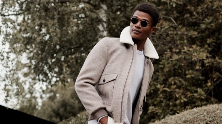 A sleek vision, O'Shea Robertson dons a jacket, sweater, and cargo trousers for Reiss' winter 2020 campaign.