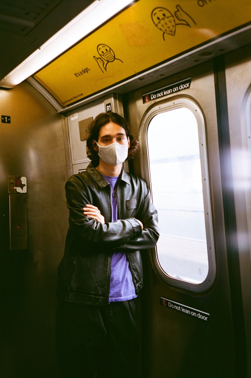 Taking the subway, Sebastião Hungerbühler dons Saturdays New York City's Harrington leather jacket and Peace pocket tee.