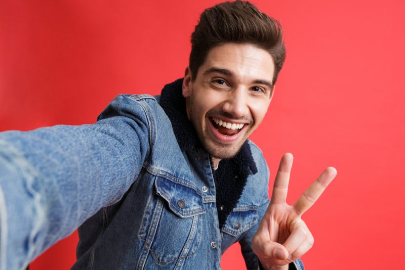 Smiling Man in Denim Jacket Posing for Selfie Smiling Man in Denim Jacket Posing for Selfie