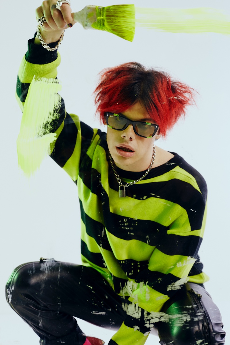 Making a style statement, Yungblud sports Ray-Ban's Caribbean Green Fluo sunglasses for the brand's Weird Collection campaign.