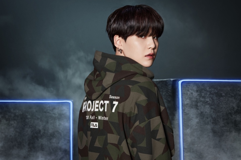 Jimin wears a camouflage hoodie from the FILA Project 7 campaign for the new collection.