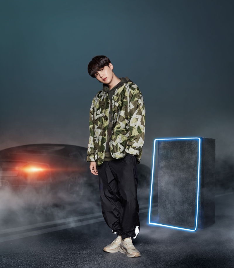 Suga rocks a FILA Project 7 lightweight quilted jacket in military khaki for the collection campaign.