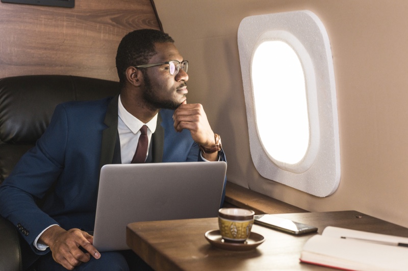 Black Man Blue Suit Business Travel Airplane Laptop Tea Cup