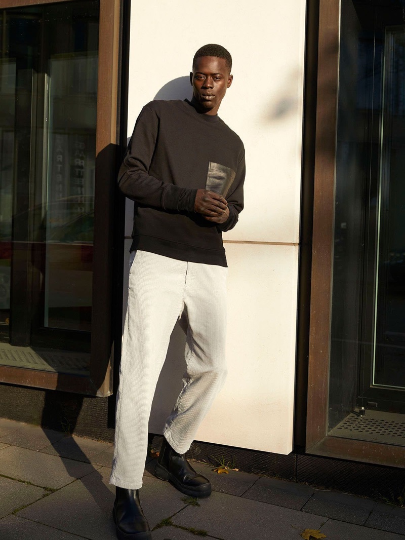 Heading out, Alpha Dia wears a casual look from COS's fall-winter 2020 men's lineup.