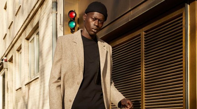Alpha Embraces Downtime Dressing in COS Alpha Dia goes on a stroll in a chic coat, sweatshirt, and corduroy pants from COS.