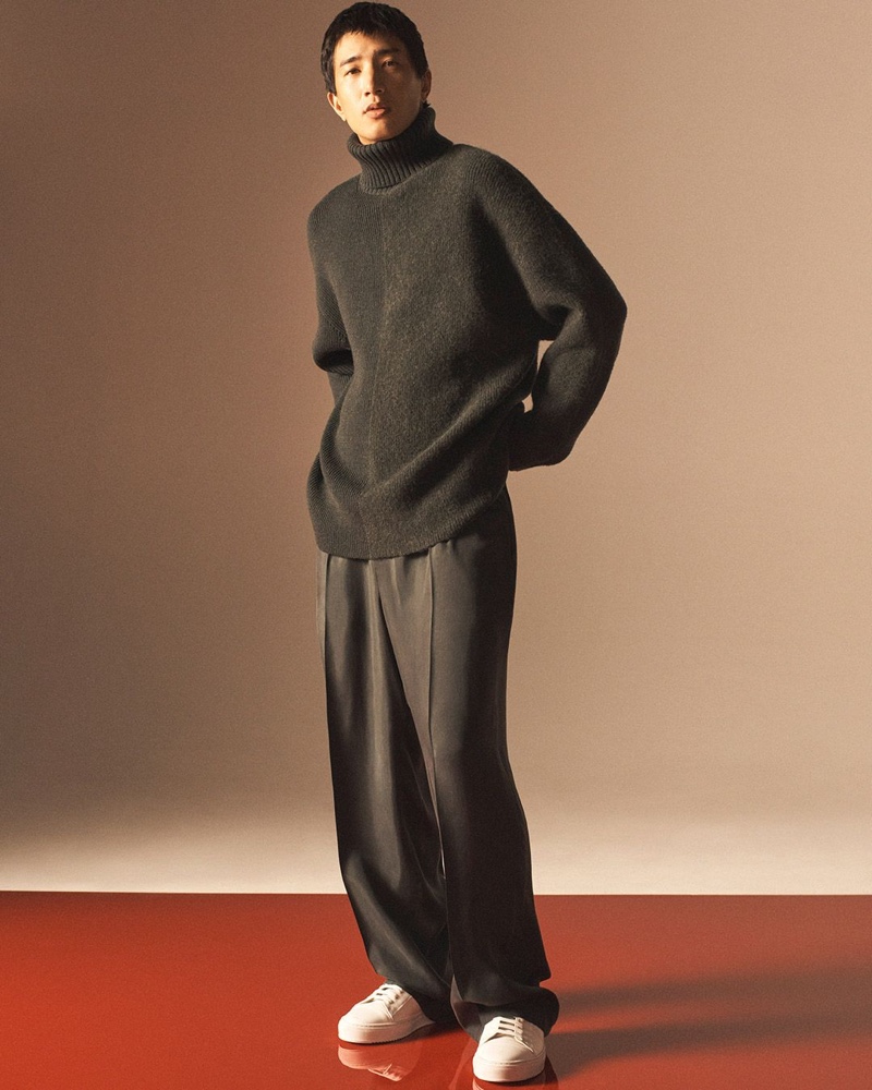 Nathaniel Dam sports an oversized turtleneck sweater with relaxed trousers for COS' holiday 2020 men's campaign.