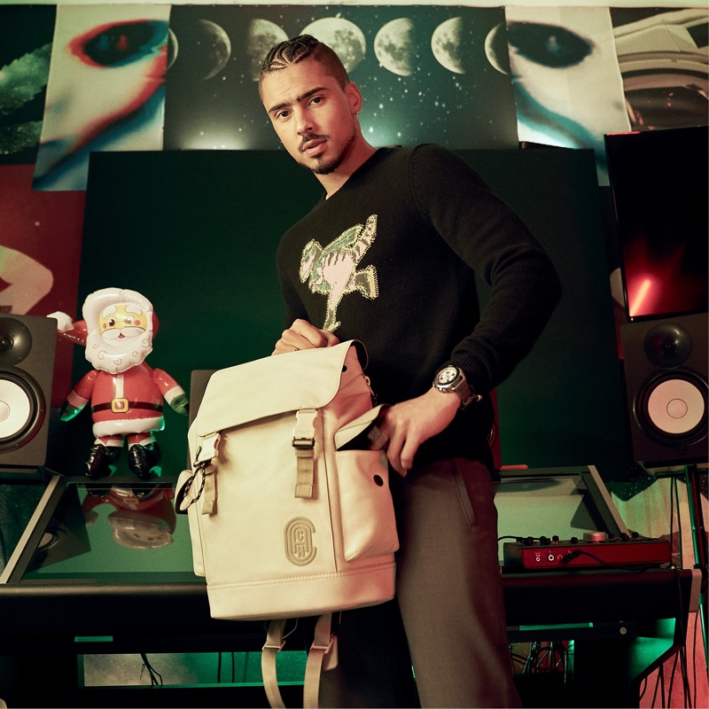 Quincy poses with Coach's Rivington backpack for the brand's holiday 2020 campaign.