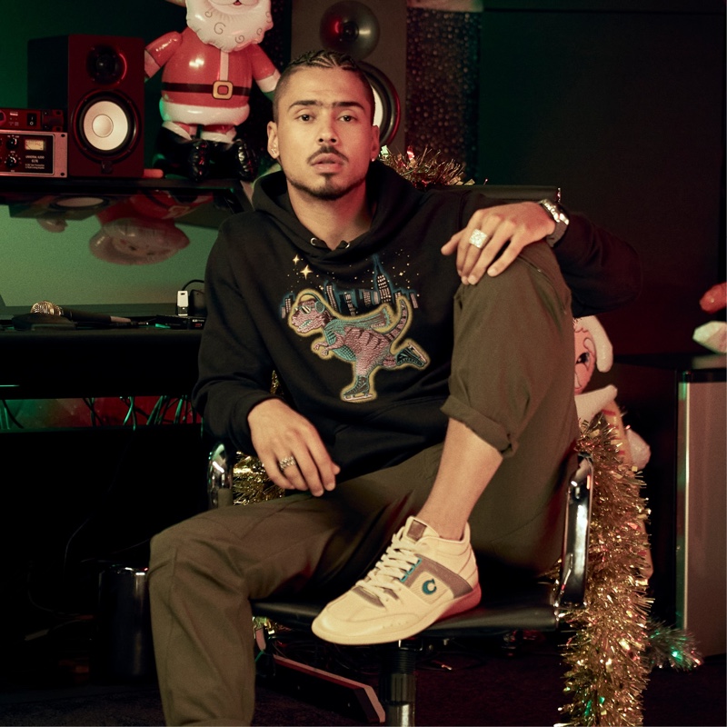 Reuniting with Coach for its holiday 2020 campaign, Quincy wears the label's CitySole mid-top sneakers.
