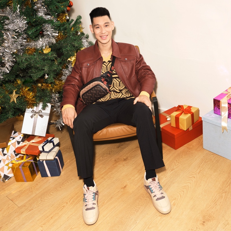 Sitting for a photo, Jeremy Lin rocks a Coach belt bag for the brand's holiday 2020 campaign.