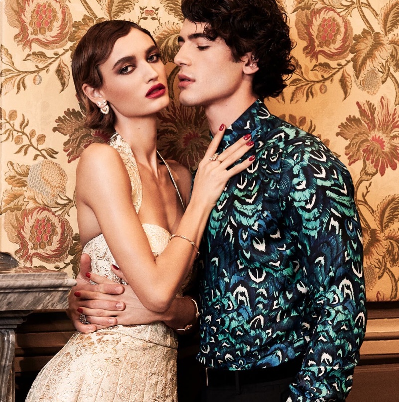 Posing with Beatrice Brusco, Davide Lenoci dons a silk printed shirt from Dolce & Gabbana.