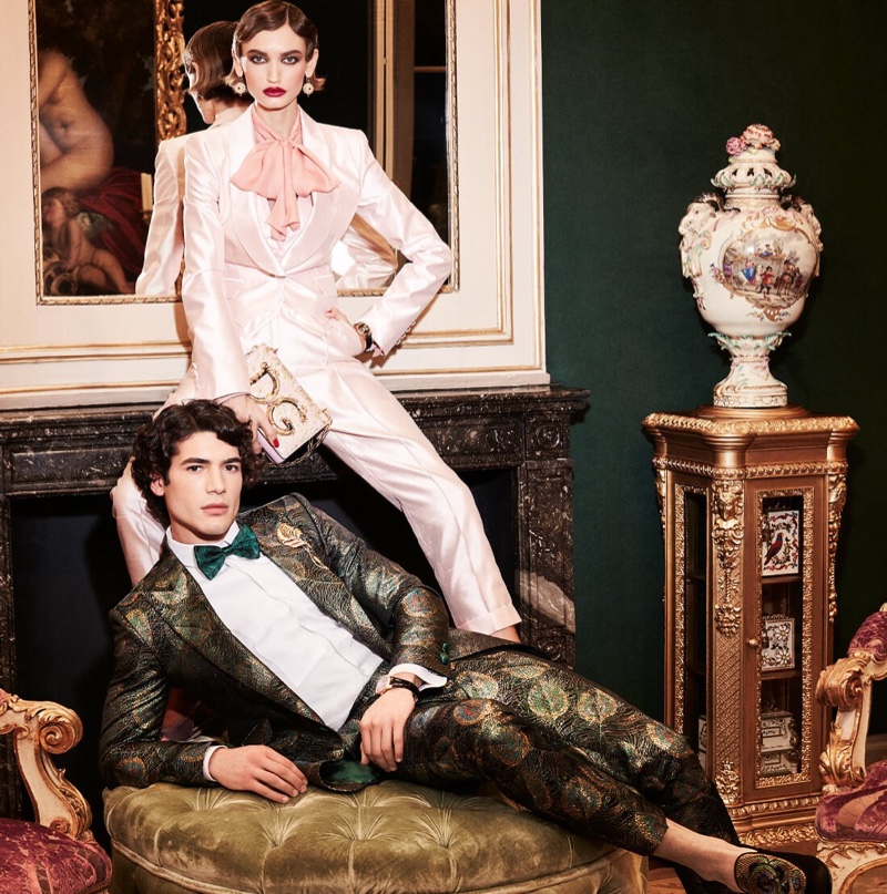 Davide Lenoci and Beatrice Brusco don elegant holiday looks from Dolce & Gabbana. More specifically, Davide dons a regal jacquard sicilia-fit jacket and pants with feather design.