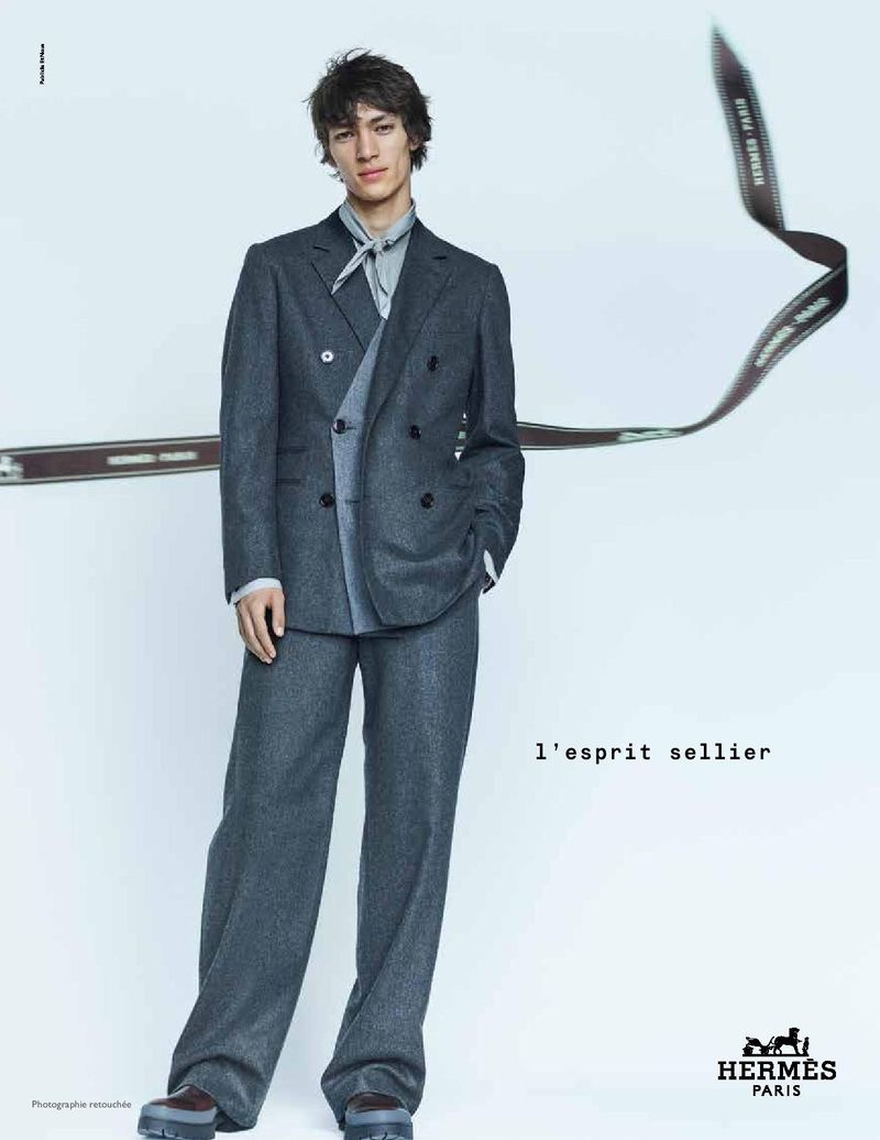 Donning a relaxed double-breasted suit in charcoal gray, Eliot Moles le Bailly appears in Hermès's fall-winter 2020 men's campaign.