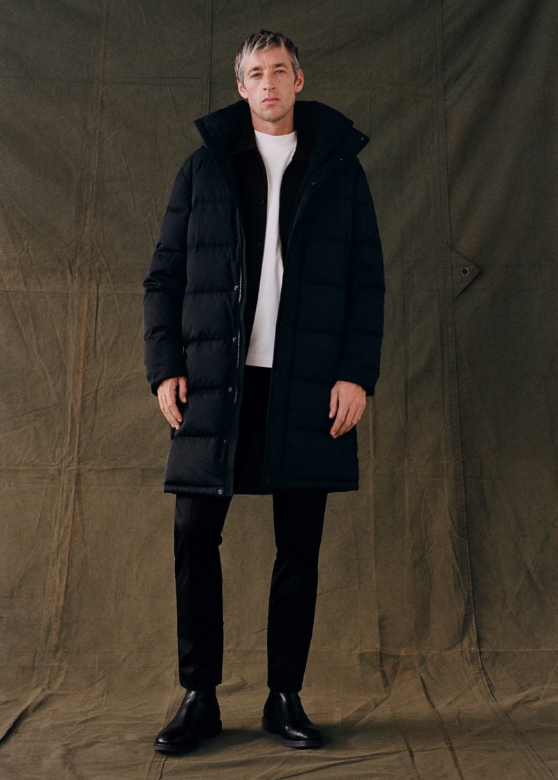 British model Joel Frampton wears a black puffer jacket with a cotton t-shirt by Mango.