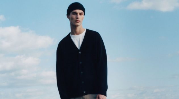 Kit Reunites with COS in New Winter Garments Embracing laid-back style from COS, Kit Butler wears a traceable cashmere cardigan, cashmere beanie, and dropped crotch tailored cotton chinos.
