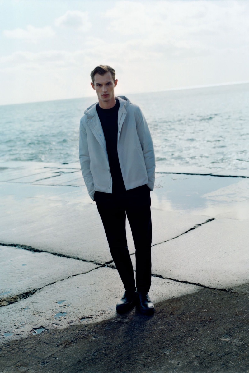 Front and center, Kit Butler models a COS merino wool sweater with skinny stretch-cotton trousers, and oversized sole canvas sneakers.