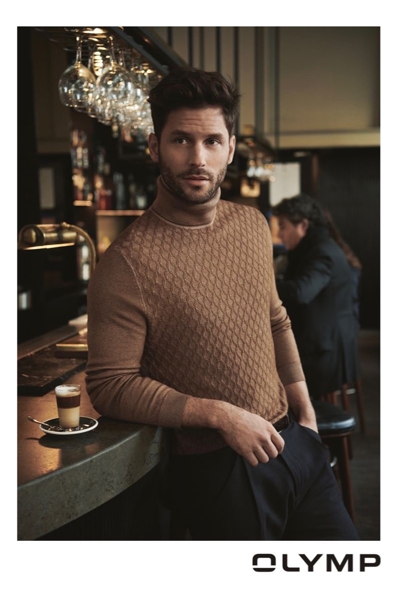 Samuel Trepanier wears a chic turtleneck sweater from OLYMP.