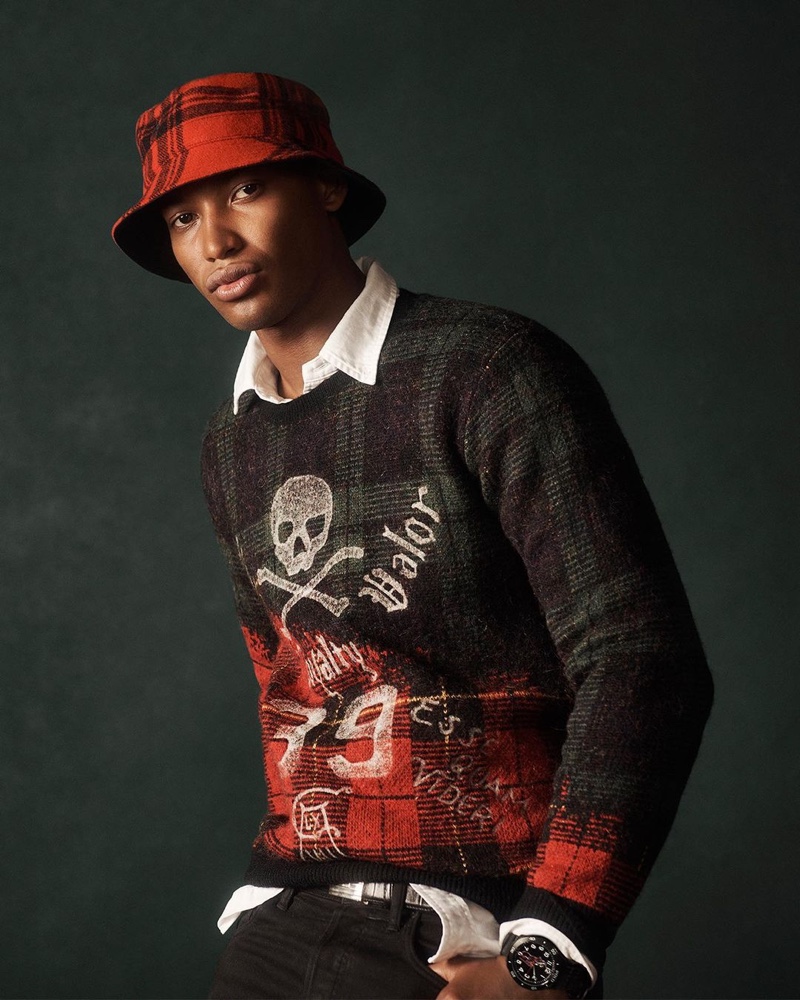 Timothy Lewis sports a rebellious take on the tartan sweater from POLO Ralph Lauren's holiday 2020 collection.