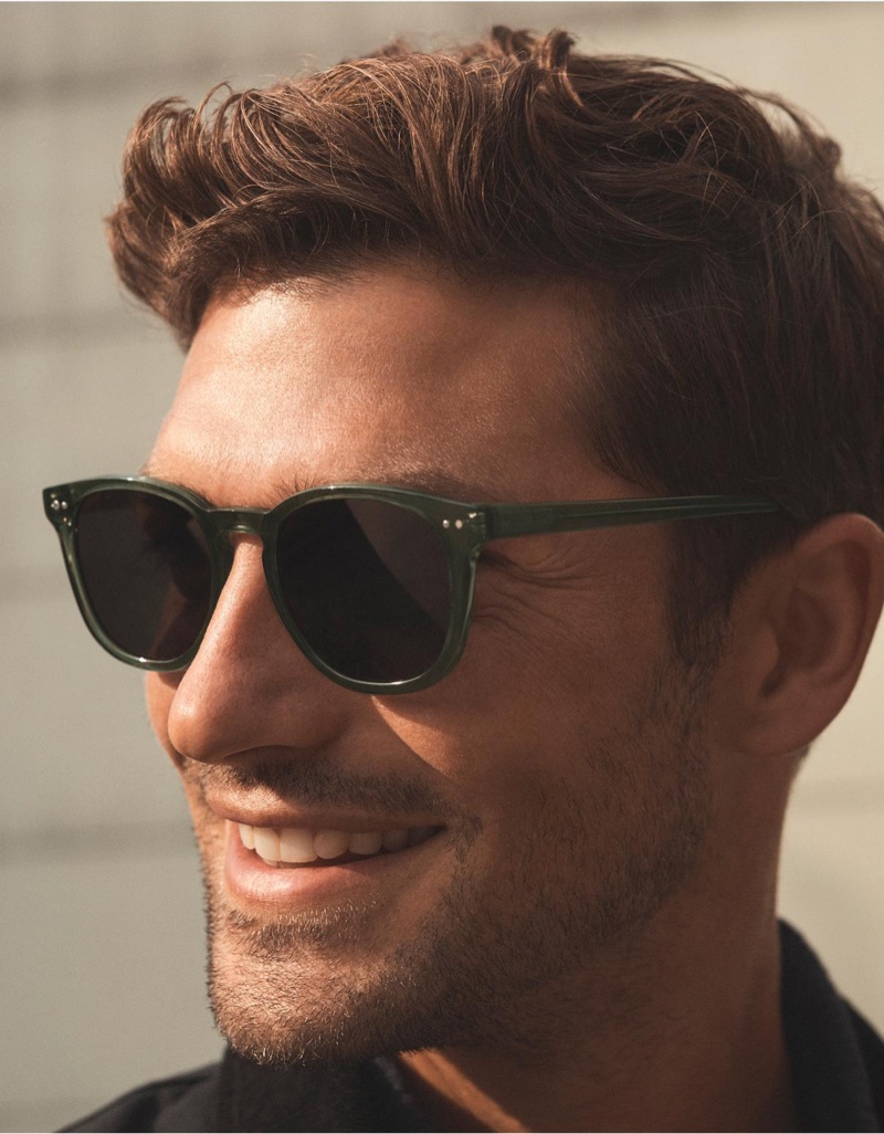 Model Benj Lee is all smiles in Warby Parker's Toddy sunglasses in seaweed crystal.