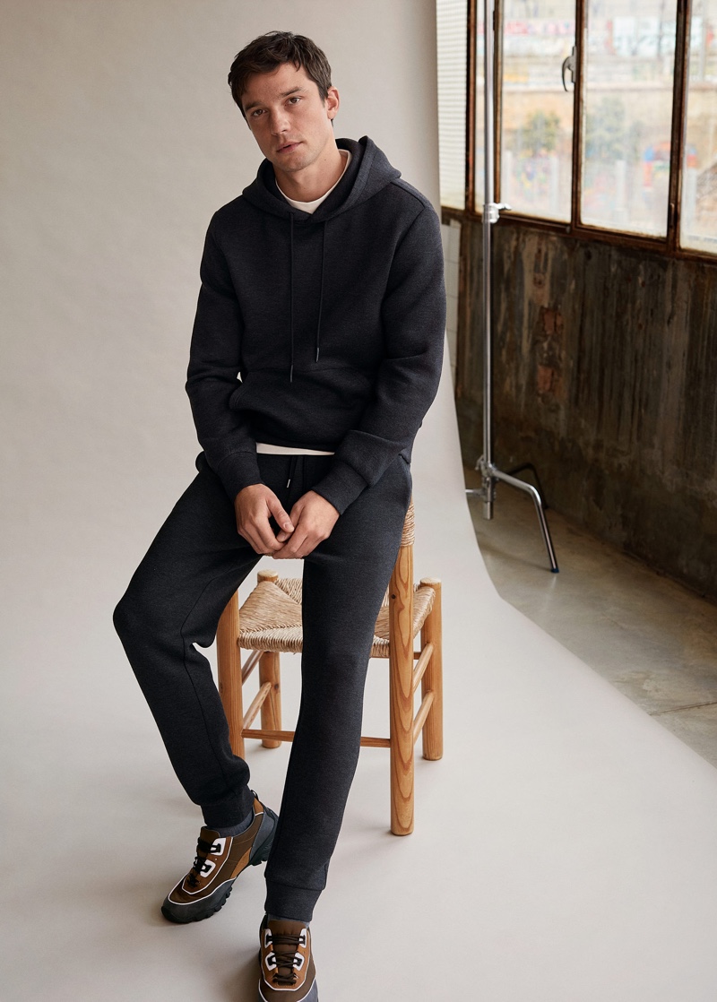 Embracing laid-back style, Alexis Petit models a matching hoodie and joggers from Mango Man.