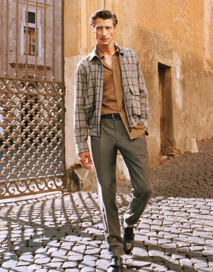 Donning a checked jacket, Jonas Mason wears a sleek look from Brioni's spring-summer 2021 men's collection.