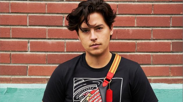 Cole Sprouse Sports Coach Disney Mickey Mouse x Keith Haring Collection Cole Sprouse rocks a Coach Disney Mickey Mouse x Keith Haring Rivington belt bag with a t-shirt.