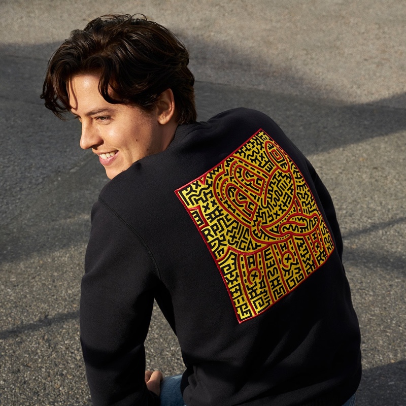 Actor Cole Sprouse dons a Coach Disney Mickey Mouse x Keith Haring sweatshirt.