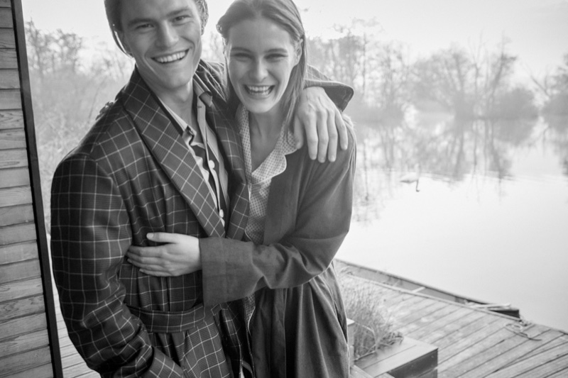 All smiles, Oliver Cheshire wears a men's navy check tasseled belt robe from Derek Rose in pure wool.