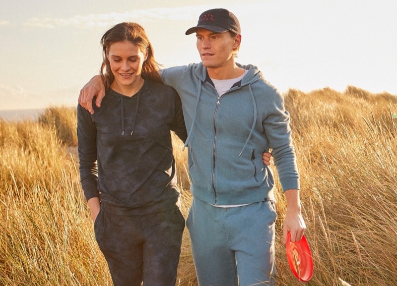 Donning a leisure look, Oliver Cheshire sports a men's hoodie and sweatpants from Derek Rose.