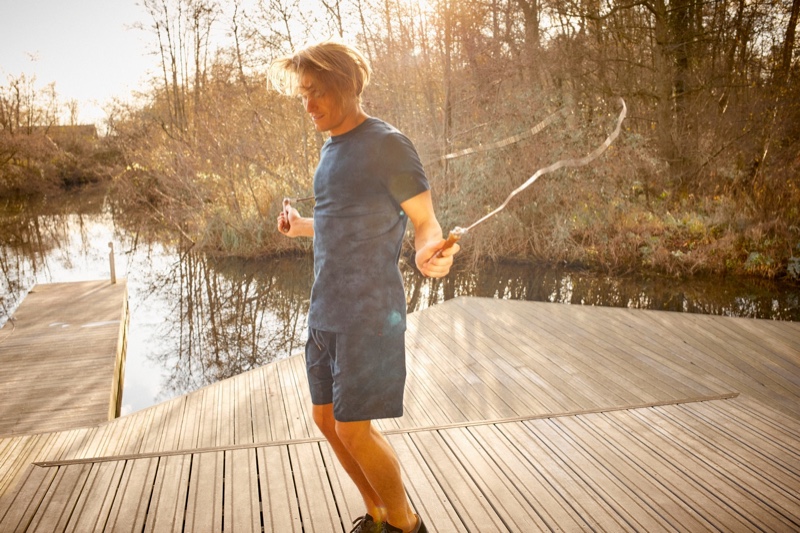 Jumping rope, Oliver Cheshire rocks a tie-dye t-shirt and jersey shorts from Derek Rose.