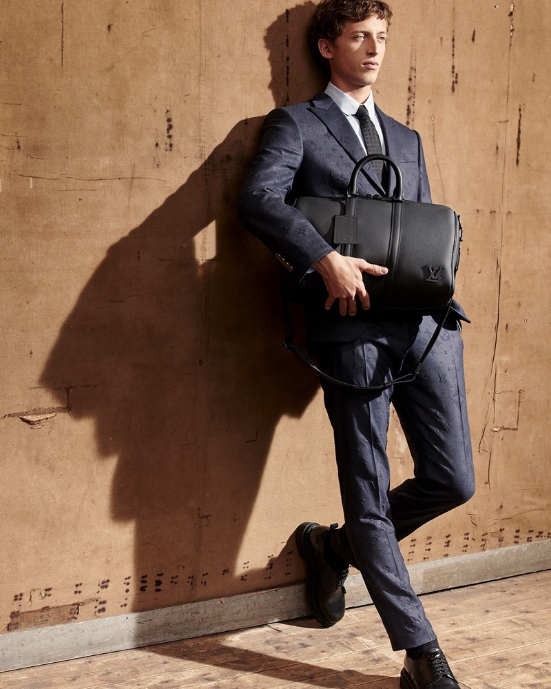 Alexis Maçon-Dauxerre takes hold of a leather bag from Louis Vuitton's new LV Aerogram collection.