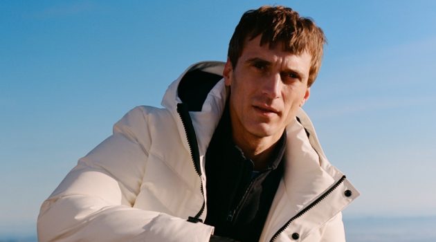 Clément Goes Sporty in Mango Man Improved Clément Chabernaud sports puffer jacket with a half-zip pullover and pants from Mango Man's Improved collection.