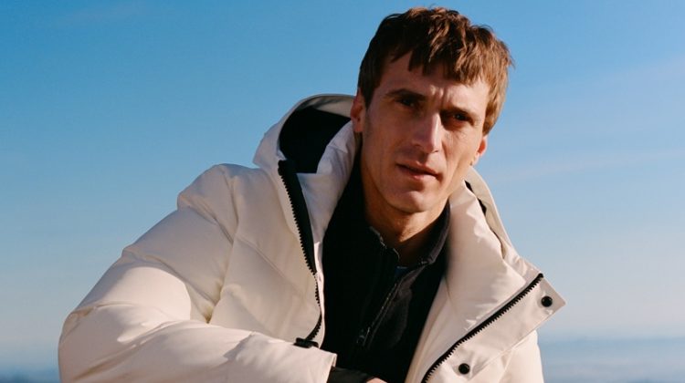 Clément Chabernaud sports puffer jacket with a half-zip pullover and pants from Mango Man's Improved collection.