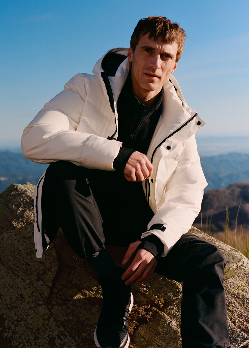 Clément Chabernaud sports puffer jacket with a half-zip pullover and pants from Mango Man's Improved collection.