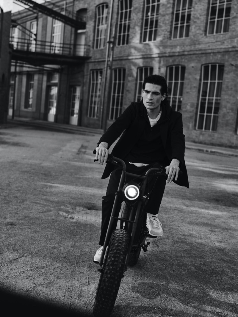 Showcasing the flexibility of Massimo Dutti's menswear, Philip Lach De Bere rides a bike.