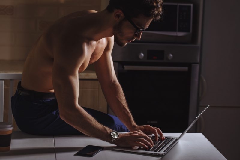 Shirtless Model Wearing Glasses on Laptop Shirtless Model Wearing Glasses on Laptop