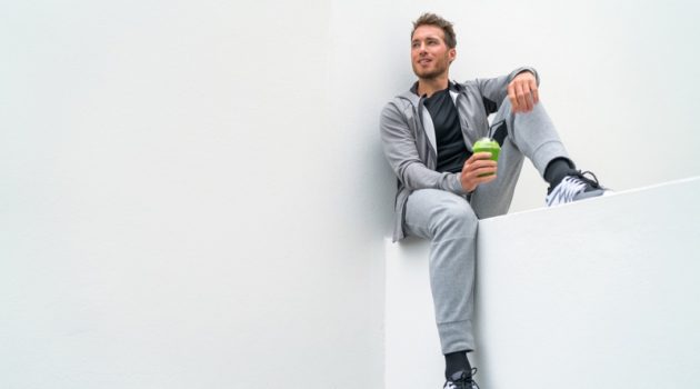 5 Ways to Style Your Sweatpants Sitting Man Grey Sweatpants Hoodie Drinking Smoothie