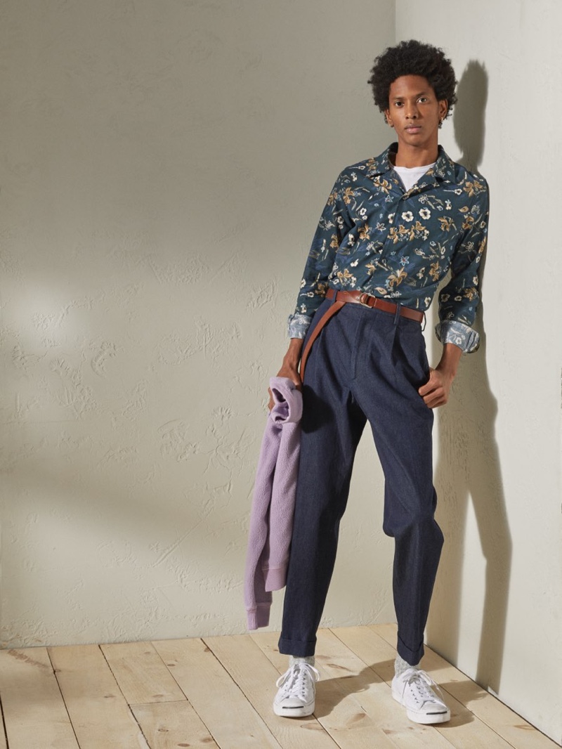 Channeling a resort cool, Rafael Mieses rocks a Todd Snyder Italian floral camp collar long-sleeve shirt in navy with Japanese denim pleated pants in indigo.