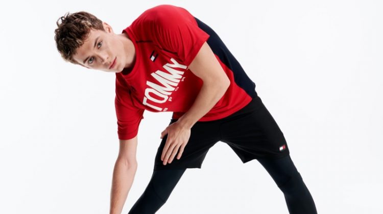 Stretching, João Knorr wears activewear from Tommy Sport.