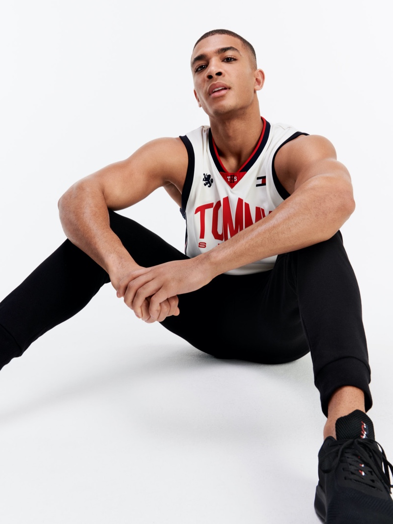 Addis Miller rocks a sleeveless jersey top and active pants from Tommy Sport.